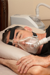 Man with sleeping apnea and CPAP machine