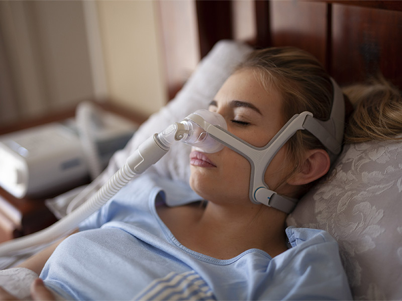 Woman using a CPAP machine.