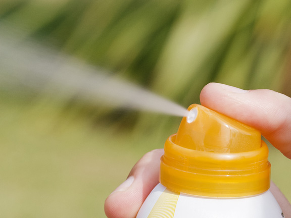 Close-up of sunscreen being sprayed that may contain benzene.